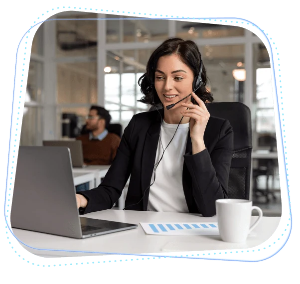 Call center agent using a VoIP phone system with a headset and laptop in a modern office